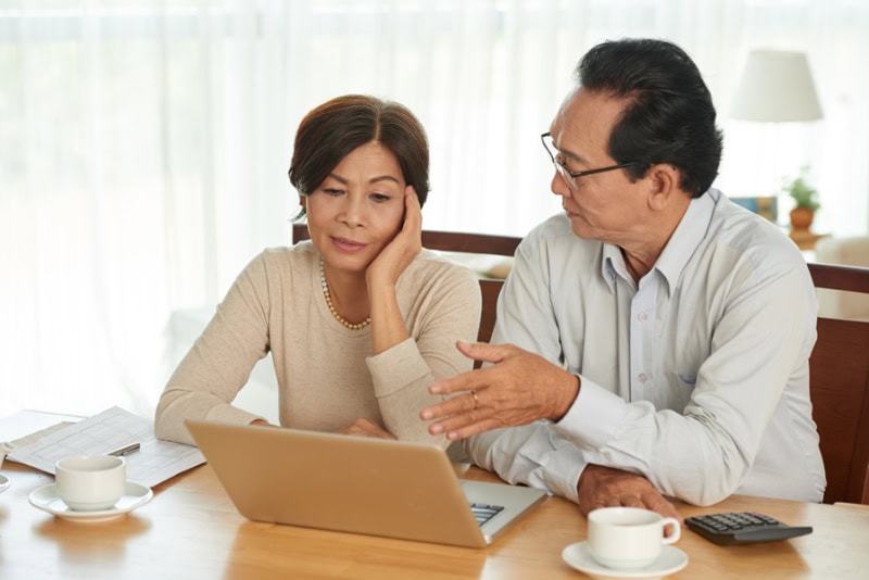 Unhappy couple discussing budget